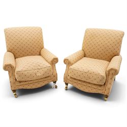 Pair of Victorian style armchairs of traditional shape, high rolled and sprung back over rolled arms, upholstered in chequered fabric with pineapple motifs with loose seat cushion, on turned feet with brass castors