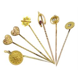 Seven Victorian and later gold stick pins including two hearts, circular diamond, 22ct gold American 1 dollar and horseshoe