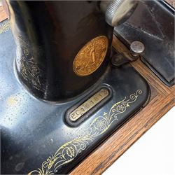 Three Singer wooden cased sewing machines 