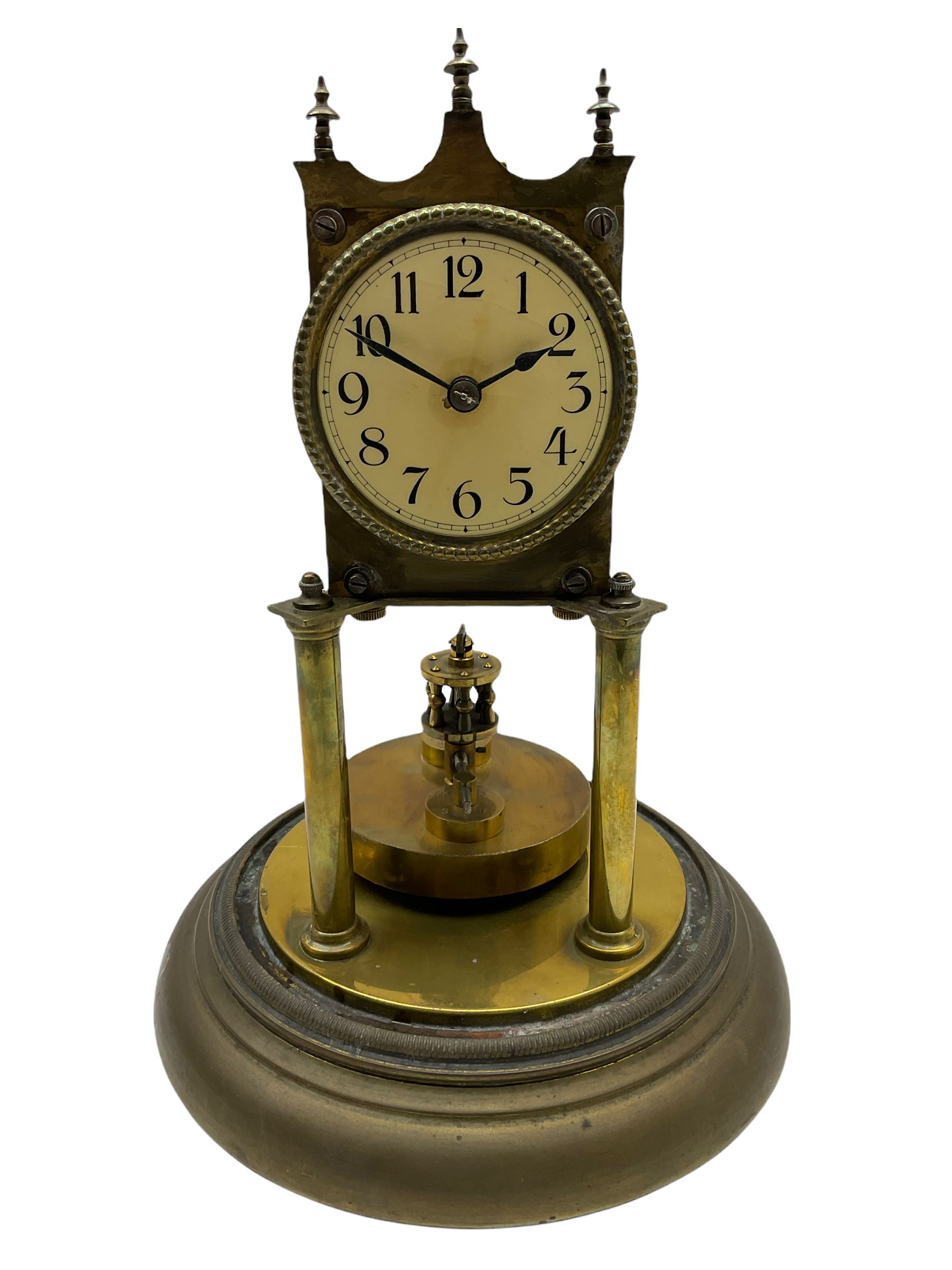 An anonymous early 20th century German 400-day torsion clock, with a circular enamel dial, upright Arabic numerals and minute track, spade hands under a glass shade, circular rotating pendulum with regulation, on a circular brass base with adjustable feet. 
H33cm
