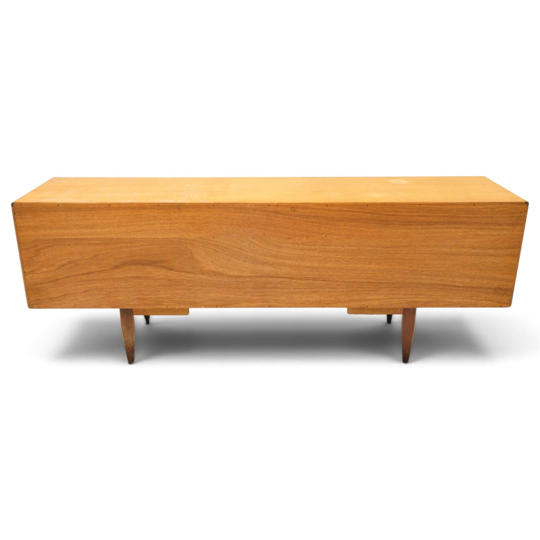 G-Plan - 'Fresco Long John' teak mid 20th century sideboard, a central bank of four drawers, flanked by twin cupboard doors, with recessed handles, on a tapering supports 