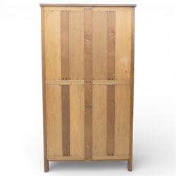 Acornman - oak adzed panelled double wardrobe, with wrought iron hinges and carved oak latch revealing a single clothes rail, with signature carved acorn to top left, by the workshop of Alan Grainger, Brandsby