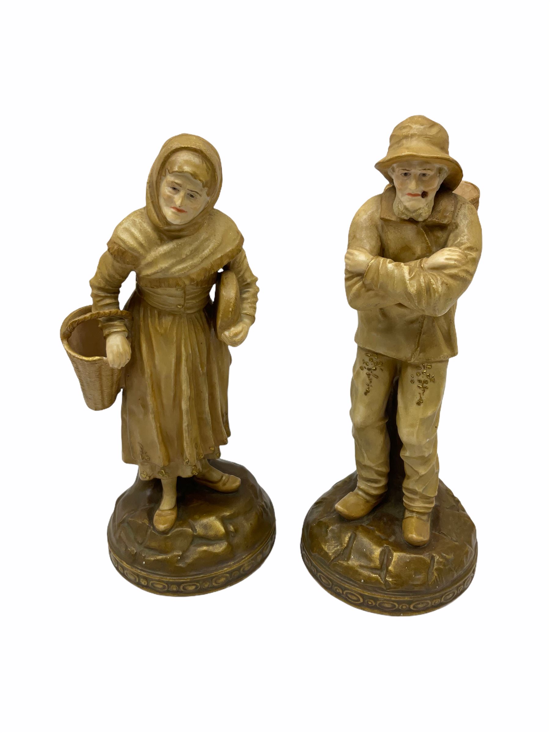 Royal Dux figure modelled as a fish seller, with applied triangle mark to the base and impressed model number 2292, H27cm, together with three Royal Dux style elephants, and a pair of Austrian Turn Wien figures, each carrying 'striker' baskets for matches. 