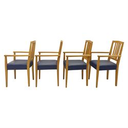 Modern twelve oak dining chairs including one 'Chairmans' chair, solid oak construction, slatted back and arm rests, blue leatherette padded seat, on tapered square supports 