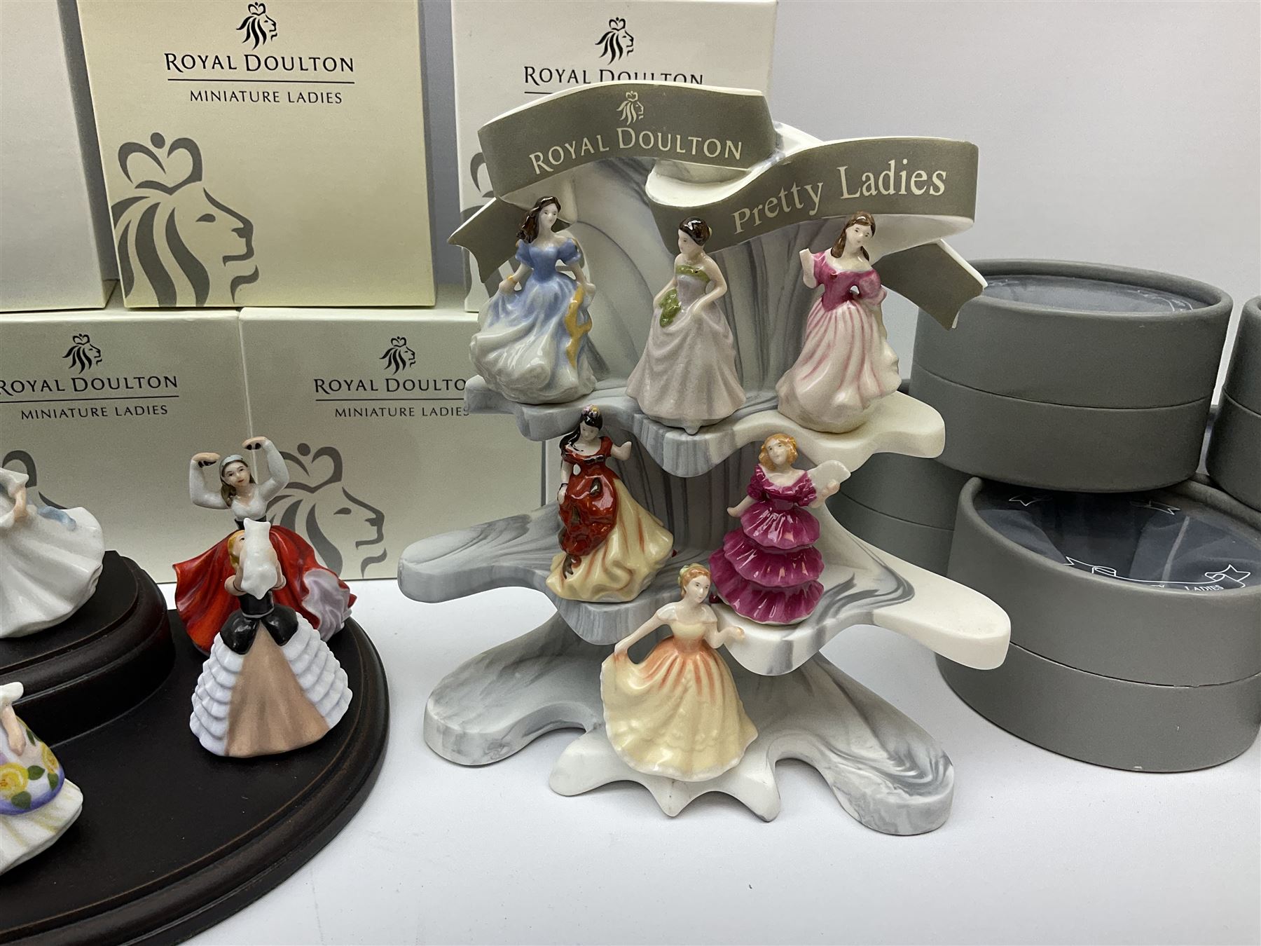 Six Royal Doulton Pretty Ladies figures, comprising Rebecca, Belle, Deborah, Jennifer, Jessica, and Lauren, with display stand, together with ten Royal Daulton Miniature Ladies figures, Ninette, Christine, Rachel, Elizabeth, Margret, Karen, Elaine, Victoria, Jane, and Susan, with display stand, all with boxes. 