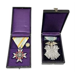 Two Japanese silver medals - Order of the Golden Kite 7th Class; and Order of the Sacred Treasure 6th Class with pin badge; each in a lacquered box with characters to the lid (2)