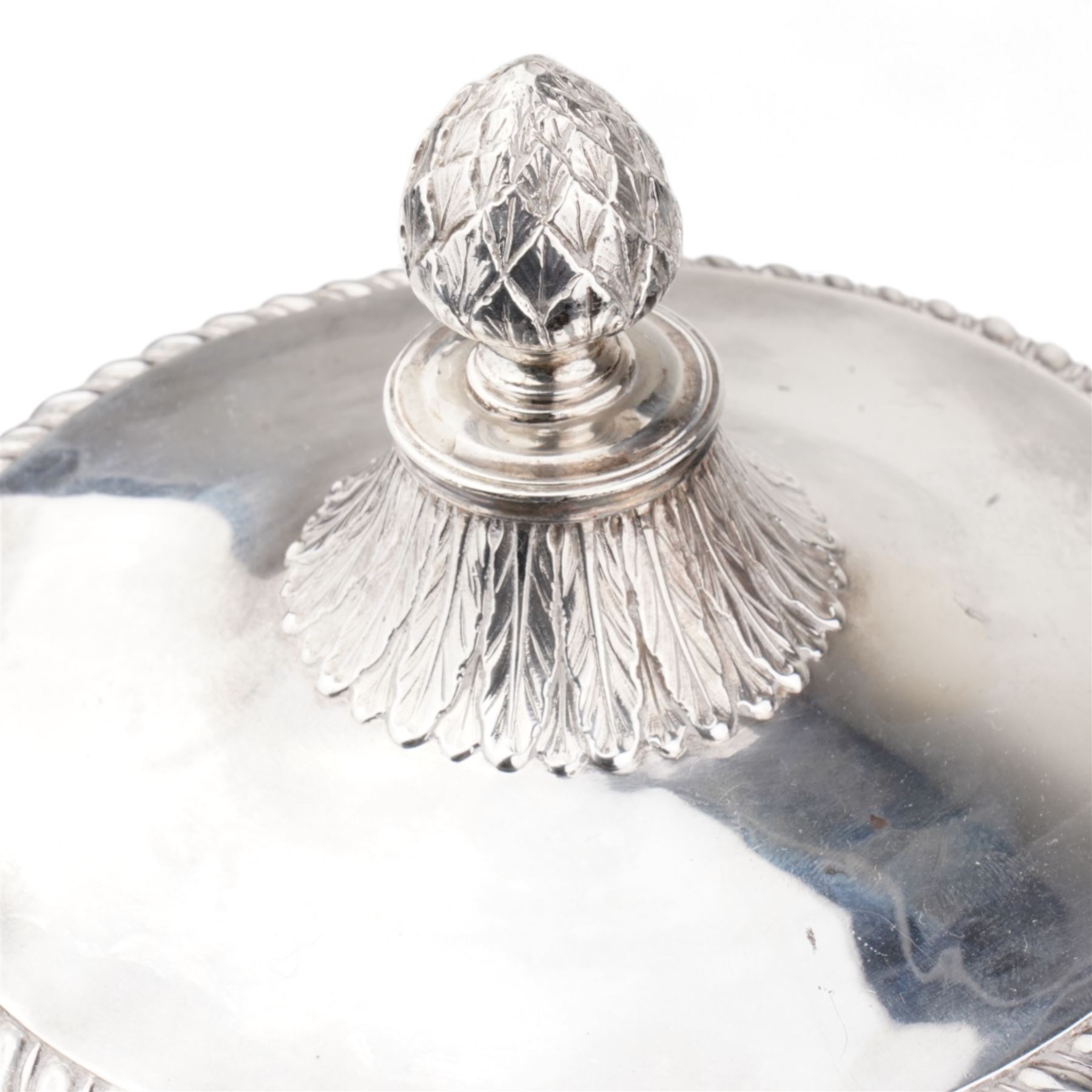 George III silver two handled campana shape cup and cover with pineapple lift, the body with cartouche surrounded by flowers above leaves and scrolls on a pedestal foot with acanthus leaf decoration H29cm London 1764, makers marks rubbed