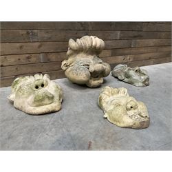 Four grotesque garden wall masks