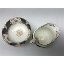 Coalport cobalt blue batwing pattern tea wares, decorated with finely enamelled floral sprays within gilt reserves, comprising teacup trio, coffee can and saucer and other cup and saucer, twin handled cake plate, milk jug and open sucrier, and circular plate retailed by T. Goode & Co London, pattern no Y2665,  all with green Coalport AD 1750 marks beneath, largest W26cm (11)