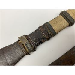 African Mandingo sword, the 75cm triple fullered blade with leather covered grip and brass pommel, in part leather covered scabbard with leaf shaped point L98cm overall