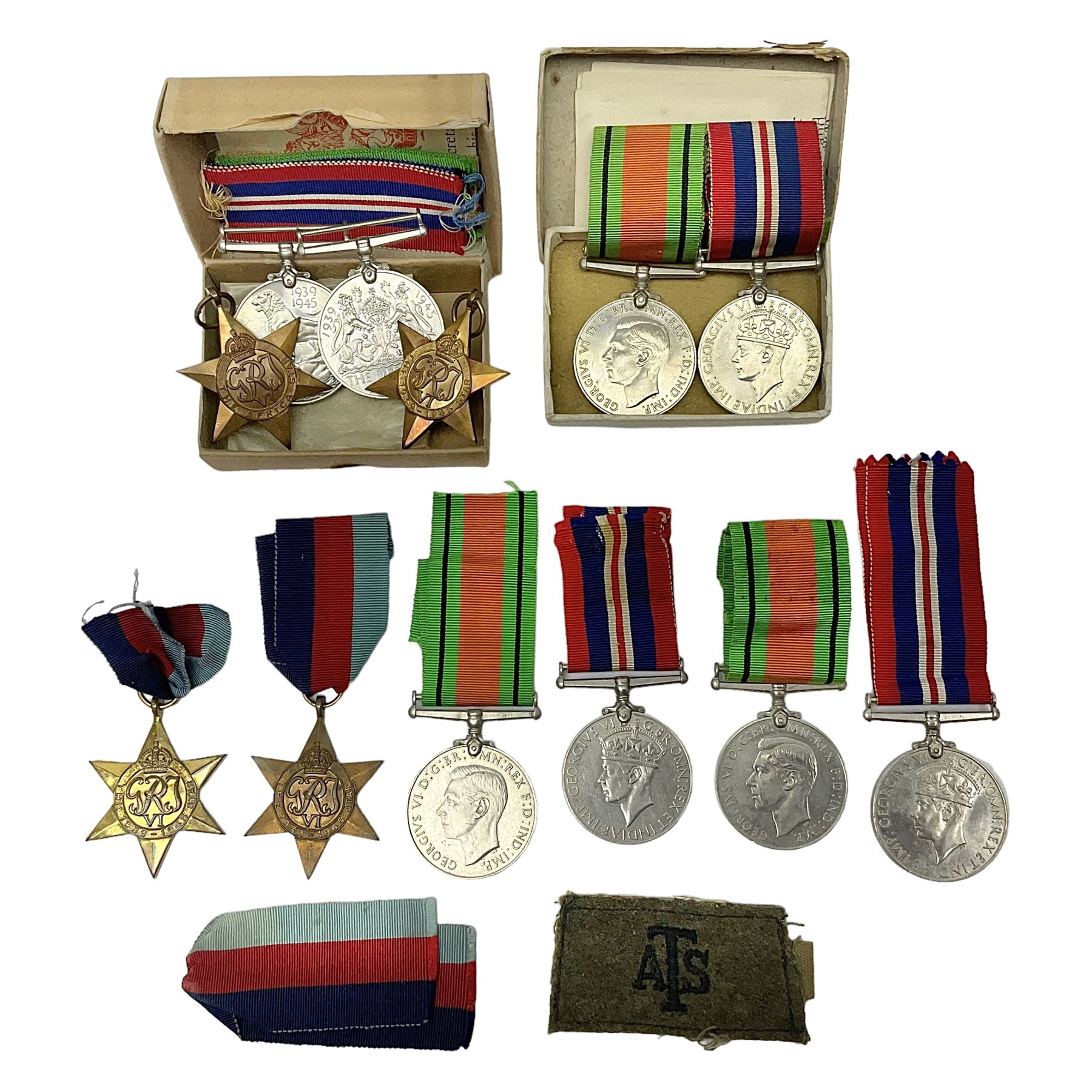 Twelve WW2 medals comprising four 1939-1945 war medals, four Defence medals, three 1939-1945 Stars and Africa Star; all with ribbons; some as groups in two issue boxes with slips
