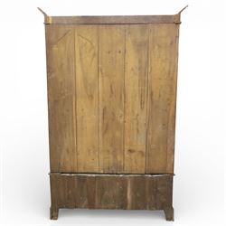 Early 20th century Art Nouveau walnut wardrobe, rectangular top over with single central mirrored panel door, the outer sides carved with sinuous foliate decoration and stylised stem motifs above recessed panels, single long drawer below with brass drop handles, on moulded plinth