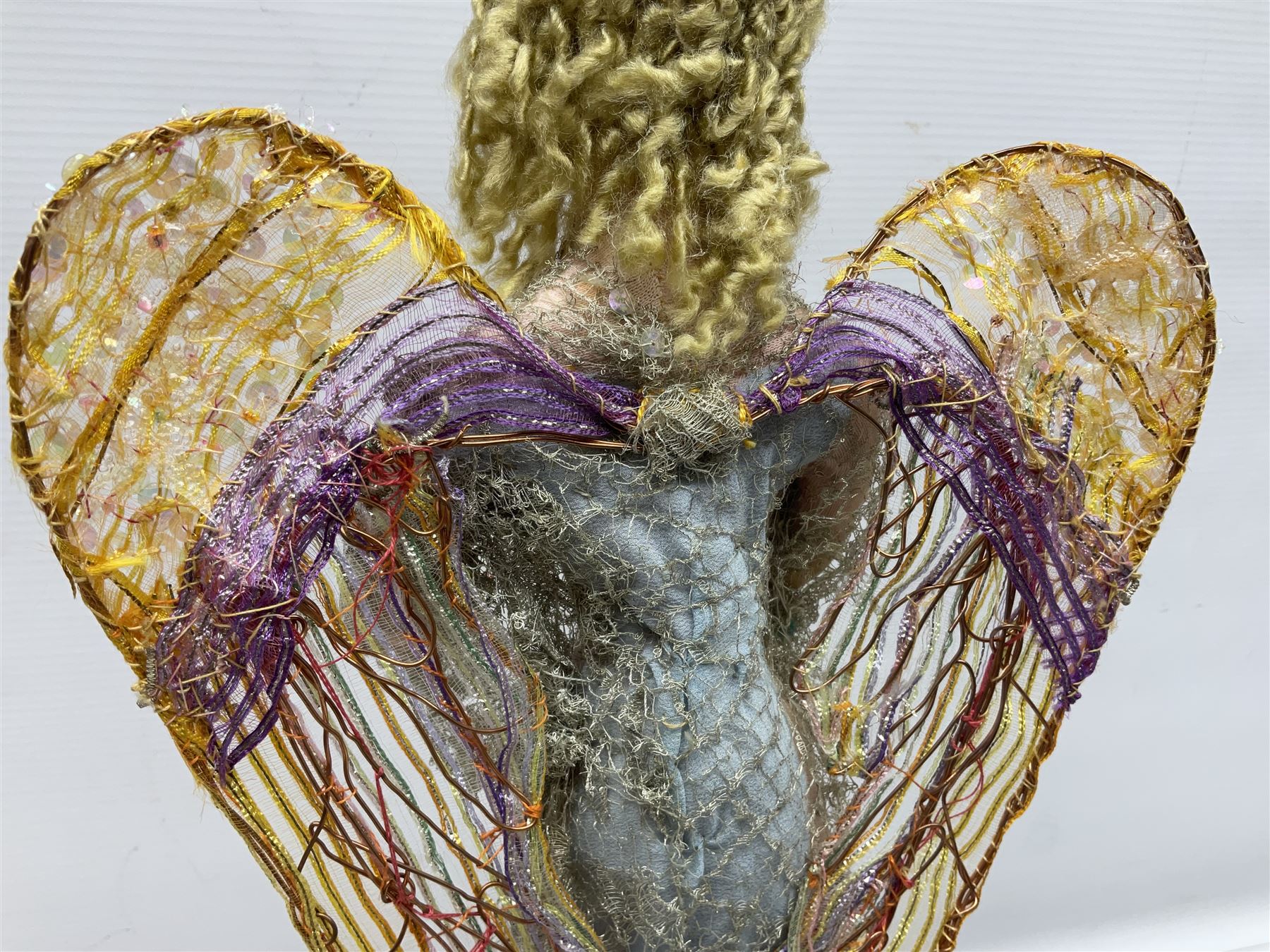Anna Meszaros Hungary - hand made needlework figurine of an Angel with metallic lace full length dress and open threadwork wings; on moulded base H45cm Auctioneer's Note: Anna Meszaros came to England from her native Hungary in 1959 to marry an English businessman she met while demonstrating her art at the 1958 Brussels Exhibition. Shortly before she left for England she was awarded the title of Folk Artist Master by the Hungarian Government. Anna was a gifted painter of mainly portraits and sculptress before starting to make her figurines which are completely hand made and unique, each with a character and expression of its own. The hands, feet and face are sculptured by layering the material and pulling the features into place with needle and thread. She died in Hull in 1998.