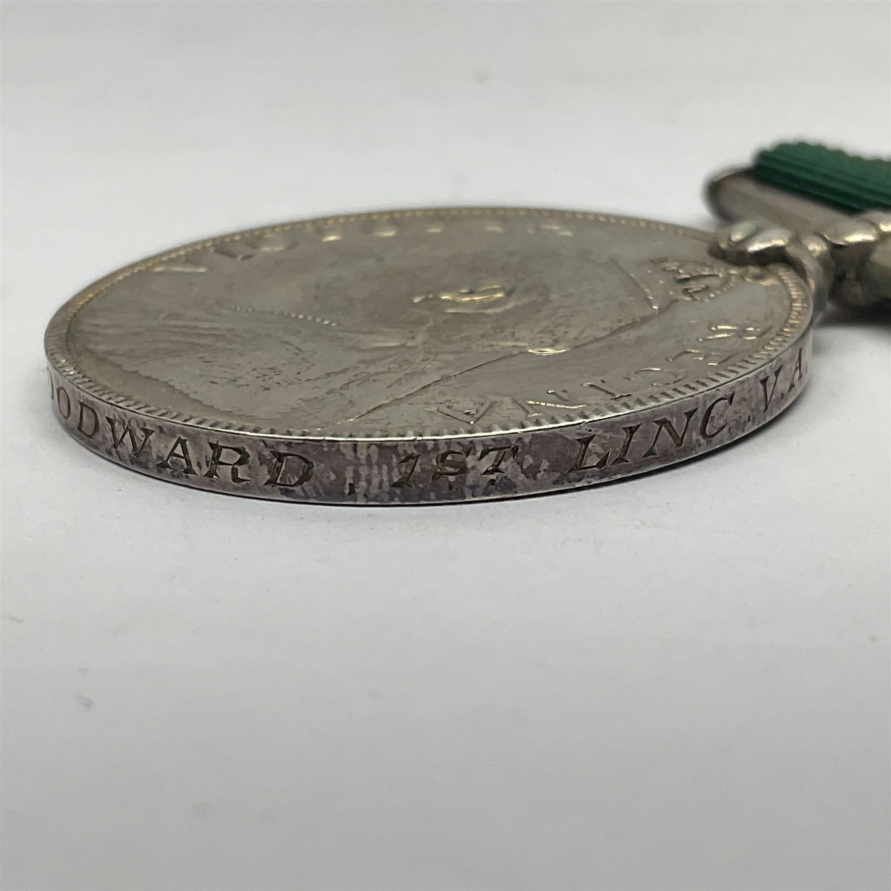 Victoria Long Service in the Volunteer Force Medal awarded to 369 Bombr. W. Woodward 1st Lincs. V.A.; and reproduction Victoria India Medal with Lucknow clasp; both with ribbons (2)