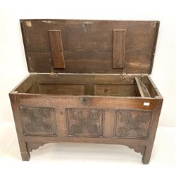 Early 19th century oak coffer blanket box, single hinged lid, three carved front panels, stile supports 