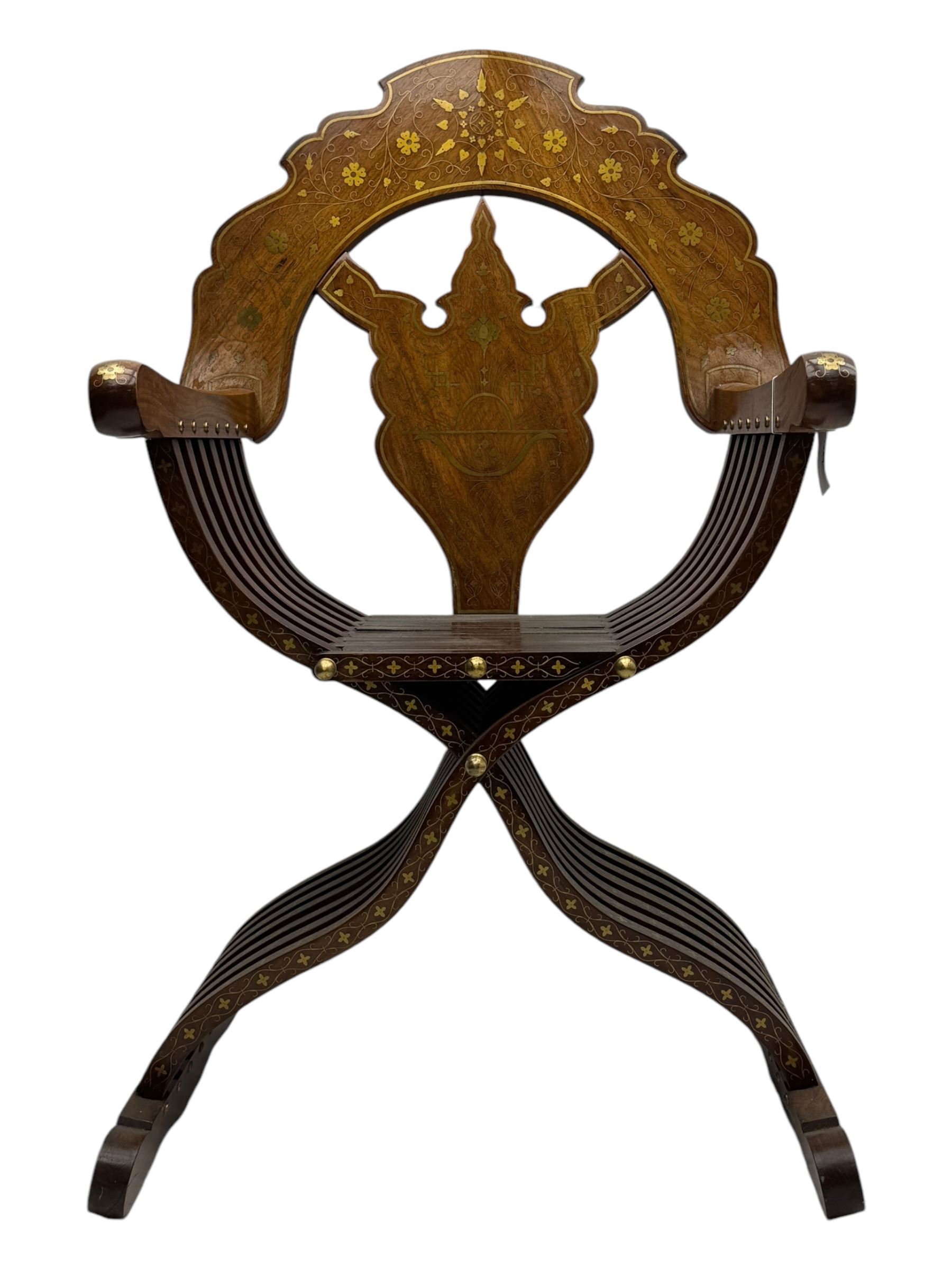 Late 20th century brass inlaid hardwood throne chair, curved X-frame form, raised shaped back inlaid with trailing leafy branches and flower heads, on sledge feet 