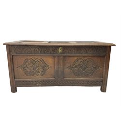 18th century oak blanket chest or coffer, rectangular hinged top with three panels and moulded edge, frieze carved with lunette and acanthus leaf decoration, two front panels carved with scrolling motif, raised on stile supports
