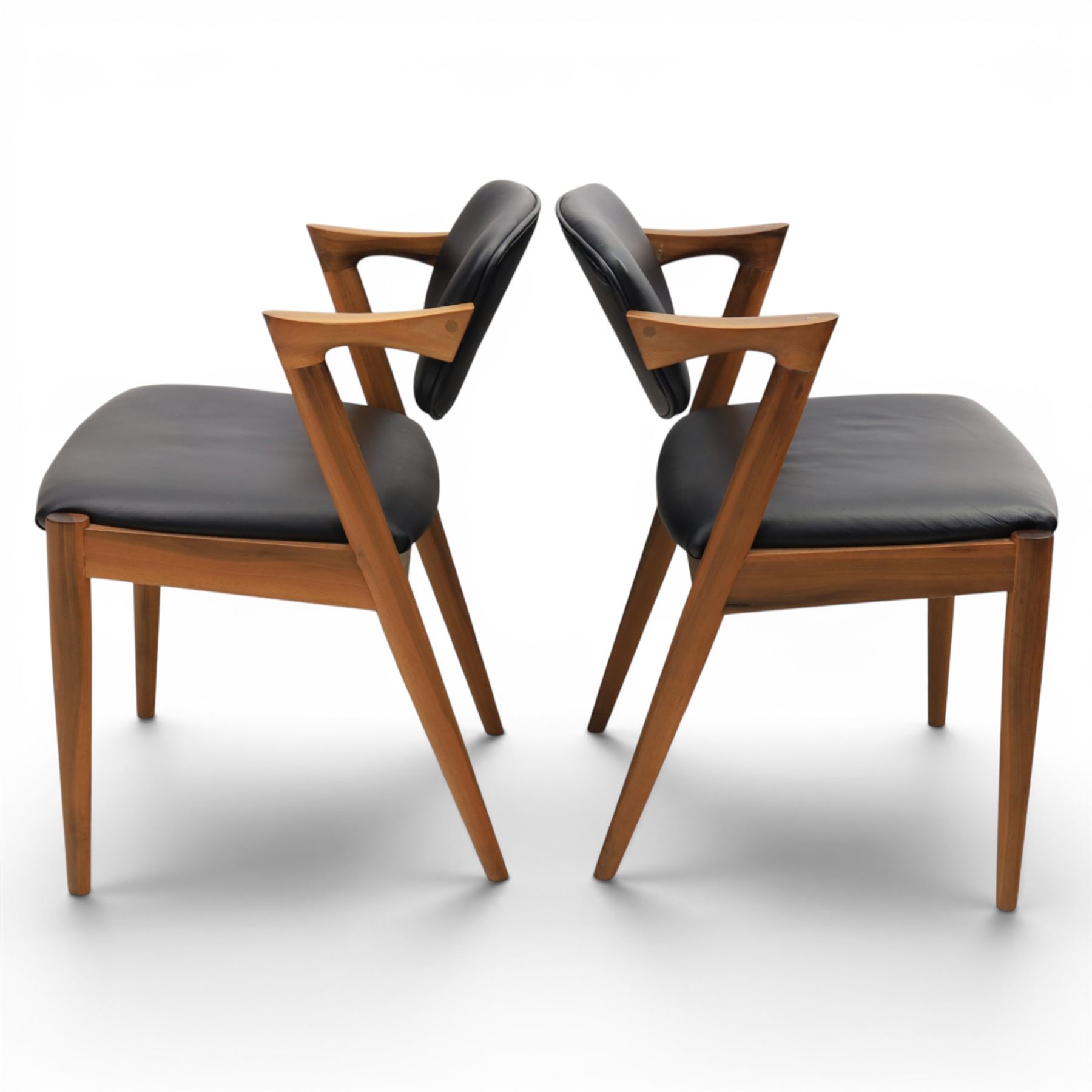 Kai Kristiansen (Danish c.1929-2022) - Pair of mid-20th century teak elbow chairs upholstered in black leatherette