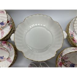 Modern Spode dinner and tea service for eight place settings, comprising dinner plates, dessert plates, side plates, twin handled soup bowls and saucers, oval serving dish, lidded tureen, teapot, teacups, saucers, milk jug, and open sucrier, each of full or part fluted form and decorated with wild flowers predominantly in tones of pink, with red and black printed mark beneath