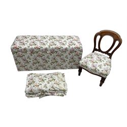 Ottoman blanket box upholstered in floral pattern fabric, matching bedroom chair and curtains