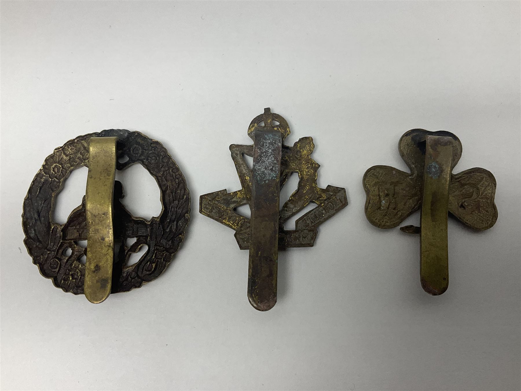 Fourteen cap badges of Irish interest including Royal Dublin Fusiliers inscribed to the slider 'From A. O'Connor 2nd Batt. Dec.2nd 1915', Connaught Rangers, South irish Horse Yeomanry, Inniskilling Fusiliers, Royal Irish Regiment etc; and seven Welsh badges including South Wales Borderers, Welsh Guards, 3rd Bn. Monmouthshire Regt. etc (21)