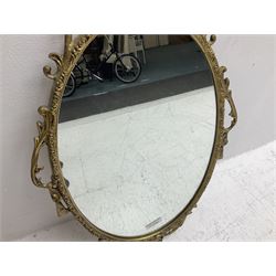 Ornate brass wall mirror with oval plate, L78cm