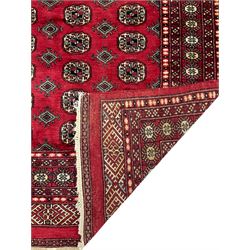 Turkmen Tekke Bokhara rug, red ground and decorated with Gul motifs, repeating multi-band border, signed on corners 