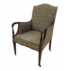 Edwardian inlaid mahogany upholstered chair, shaped arms and turned arm supports, square tapering front supports terminating at brass castors 