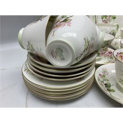 Royal Doulton Apple Blossom pattern tea service for twelve, comprising twelve saucers, twelve tea plates, twelve teacups, milk jug, sucrier and two cake plates