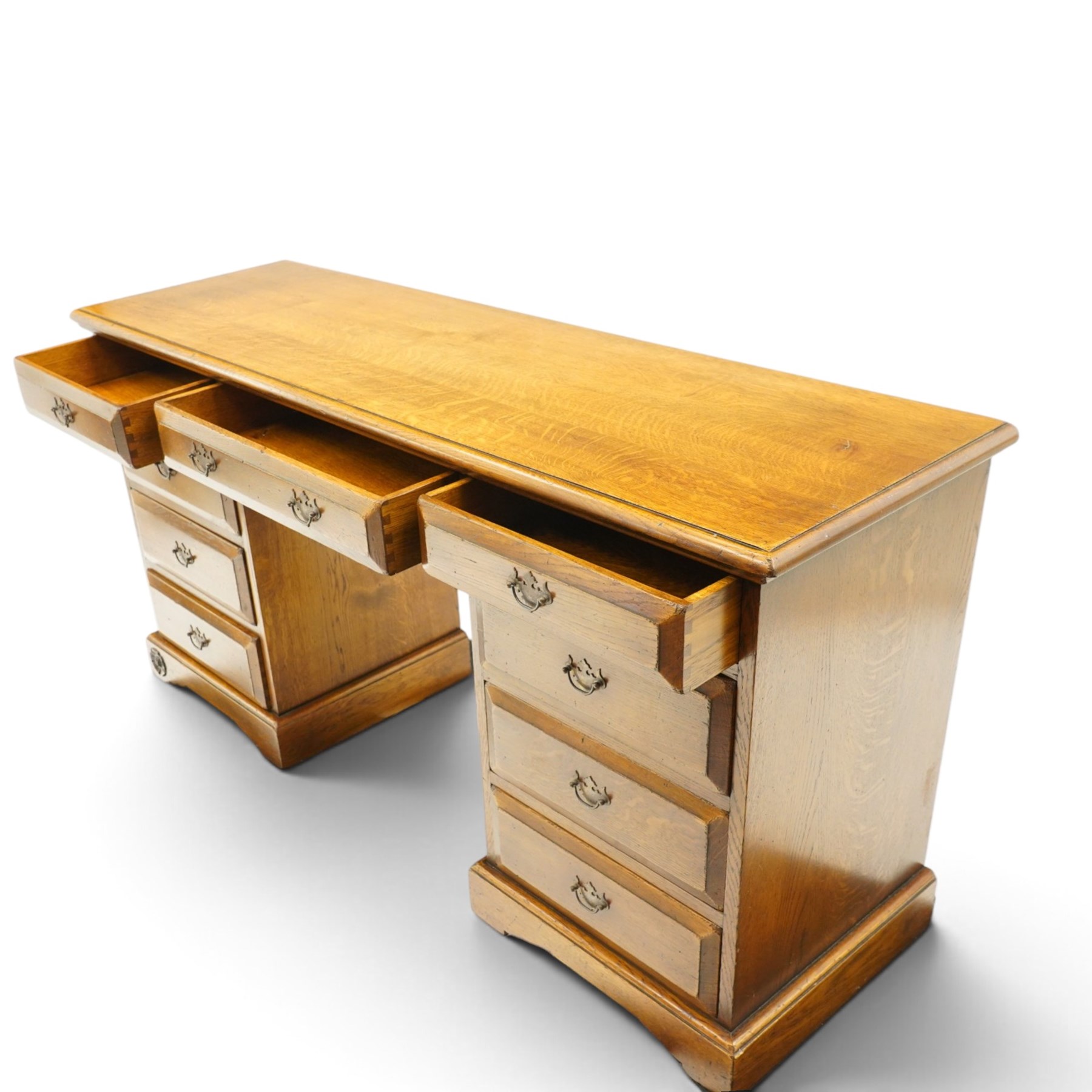 Royal Oak Furniture Company Of Grassington - Georgian design oak kneehole desk, rectangular top with moulded edge, fitted with central frieze drawer flanked by eight graduating drawers, raised on skirted base
