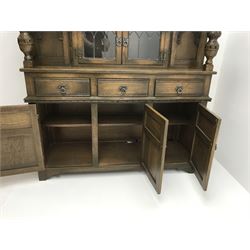20th century medium oak drawer leaf dining table, carved cup and cover supports on shaped sledge feet (W258cm, H77cm, D91cm) with a set eight (6+2) chairs (W55cm) and oak court cupboard (W137cm, H137cm, D46cm)