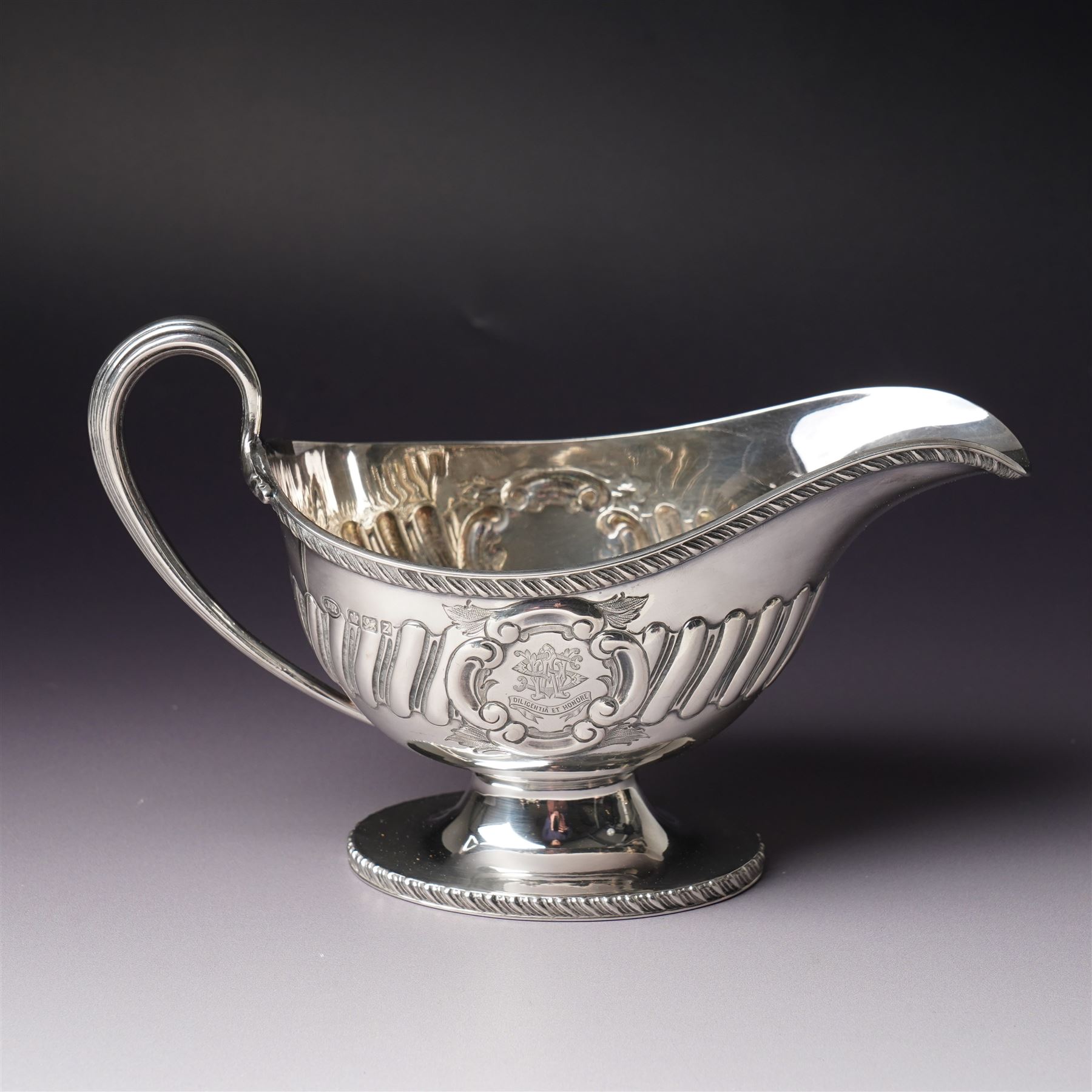 Victorian silver sauce boat engraved with a monogram Sheffield 1892 Maker John Round  & Son Ltd, another with crimped rim Birmingham 1912 Maker Elkington & Co, two silver pepperettes and a small silver challenge cup