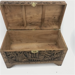  Early 20th century camphor wood chest, hinged lid with clasp and stay, heavily carved depicting town scene, shaped bracket supports, W102cm, H61cm, D51cm  
