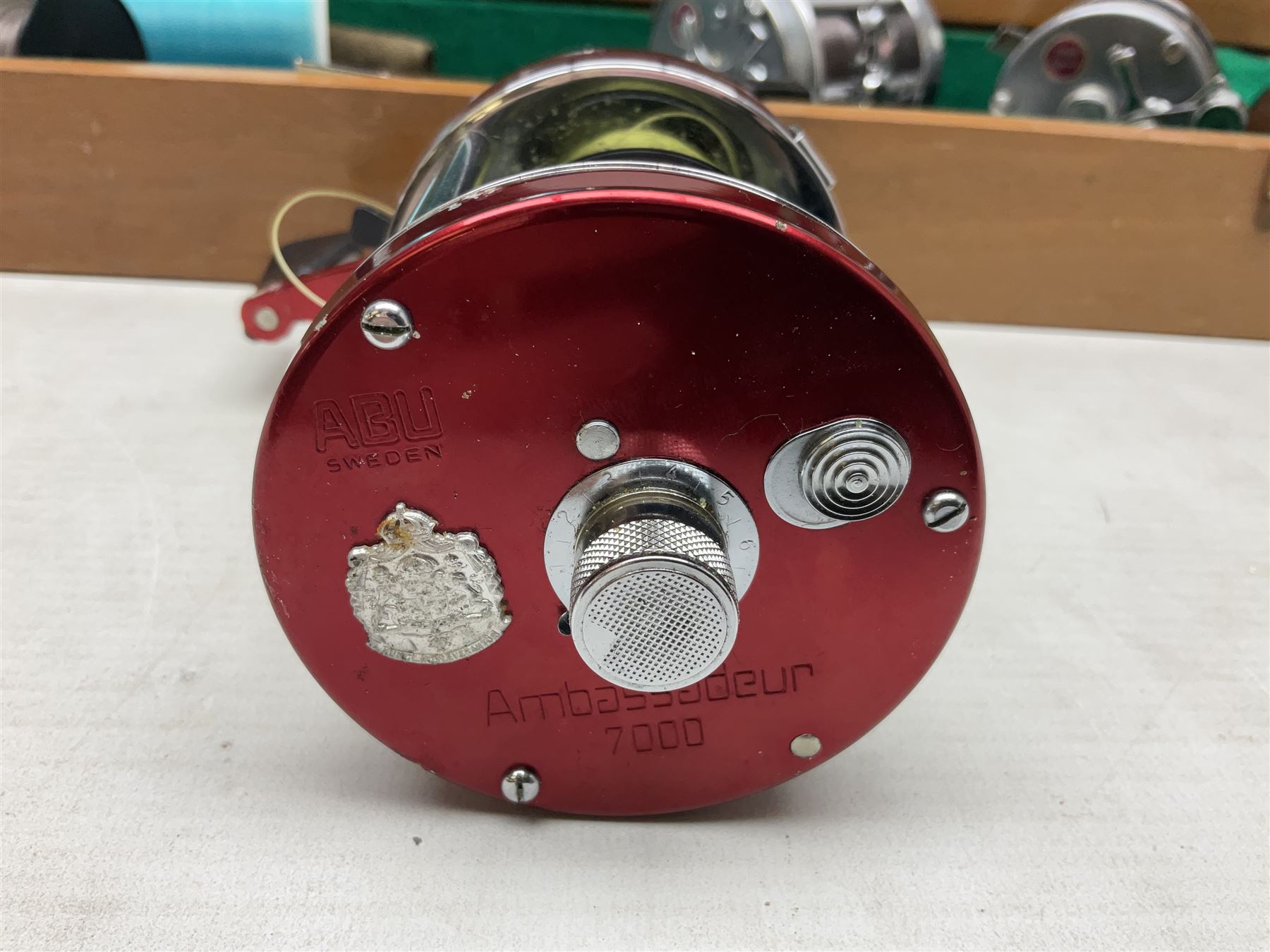 Four Abu fishing reels, comprising Ambassadeur 9000, Ambassadeur 7000, Ambassadeur 5500 and Ambassadeur 6500, together with additional line, hardy fishing bag and two wooden boxes