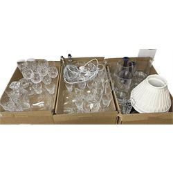 Pair of glass table lamps of tapering form with pleated fabric shads, together with other glass ware to include decanter, drinking glasses, candelsticks, bowl etc in three boxes