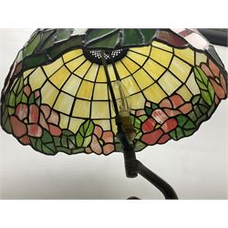Tiffany style lamp in the form of a semi nude woman holding up a leaded lampshade together with a similar table lamp