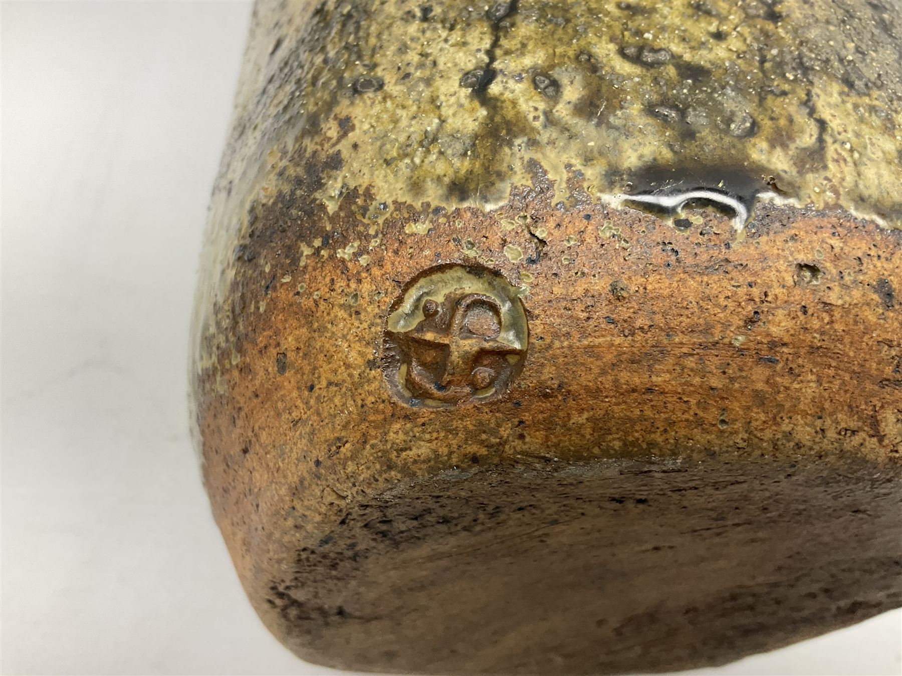 Janet Leach (American, 1918-1997) for Leach Pottery; studio pottery Bizen style vase of tapering form, the stoneware body decorated in a mottled green and brown dripped ash glaze, with impressed J.L. monogram and stamp marks beneath, H30cm