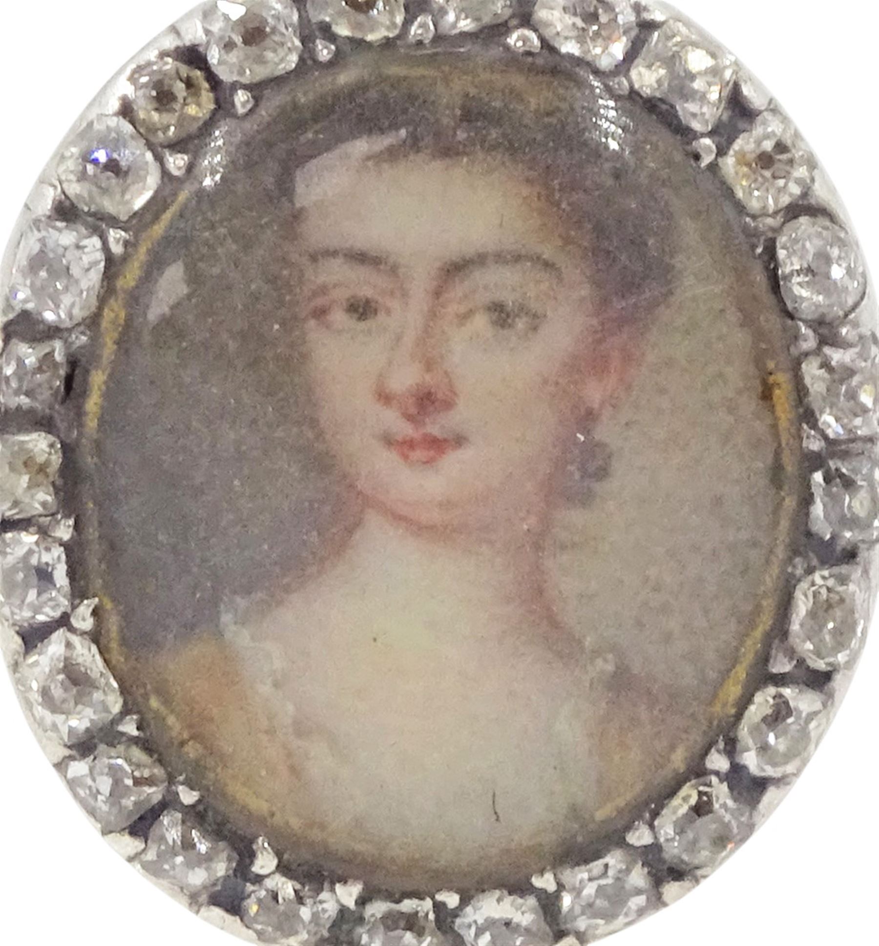 18th/ 19th century gold diamond portrait ring, set with an oval miniature of a woman on ivory, under a glazed panel, with old cut diamond surround and rope twist shank. This lot has been registered for sale under Section 10 of the APHA Ivory Act