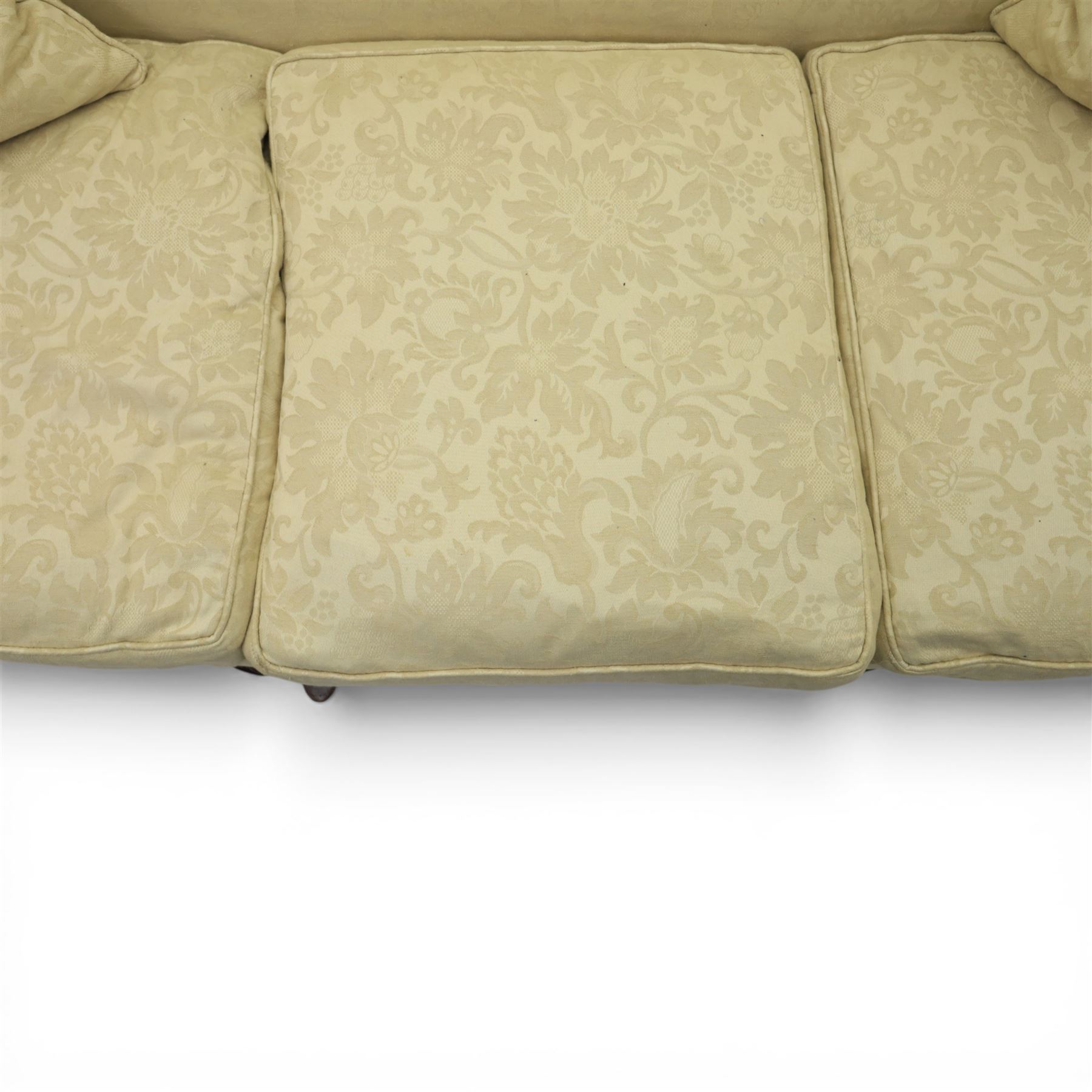 19th century Queen Anne style cream foliate upholstered three seat settee, the shaped and waisted back with serpentine cresting, padded arms over loose seat cushions, raised upon carved cabriole supports with shell carved knees