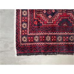 Baluchi rug, red and blue ground with repeating geometric design, the guarded border decorated with stylised motifs