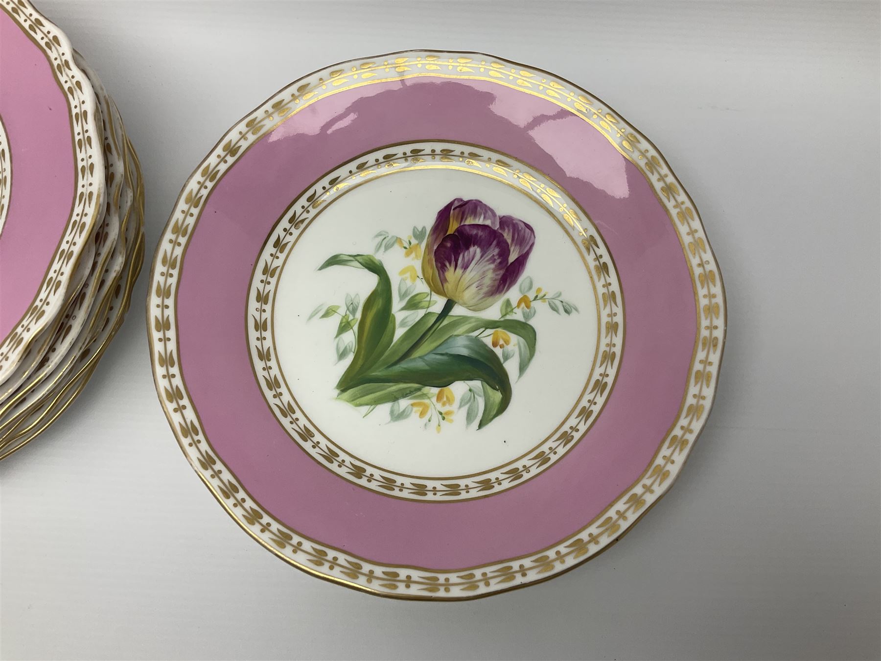 Victorian Copeland, Botanical dessert service, decorated with floral sprigs to the centre with a pink and gilt border, comprising five comports and seven plates, largest comport H20cm, plate D22cm