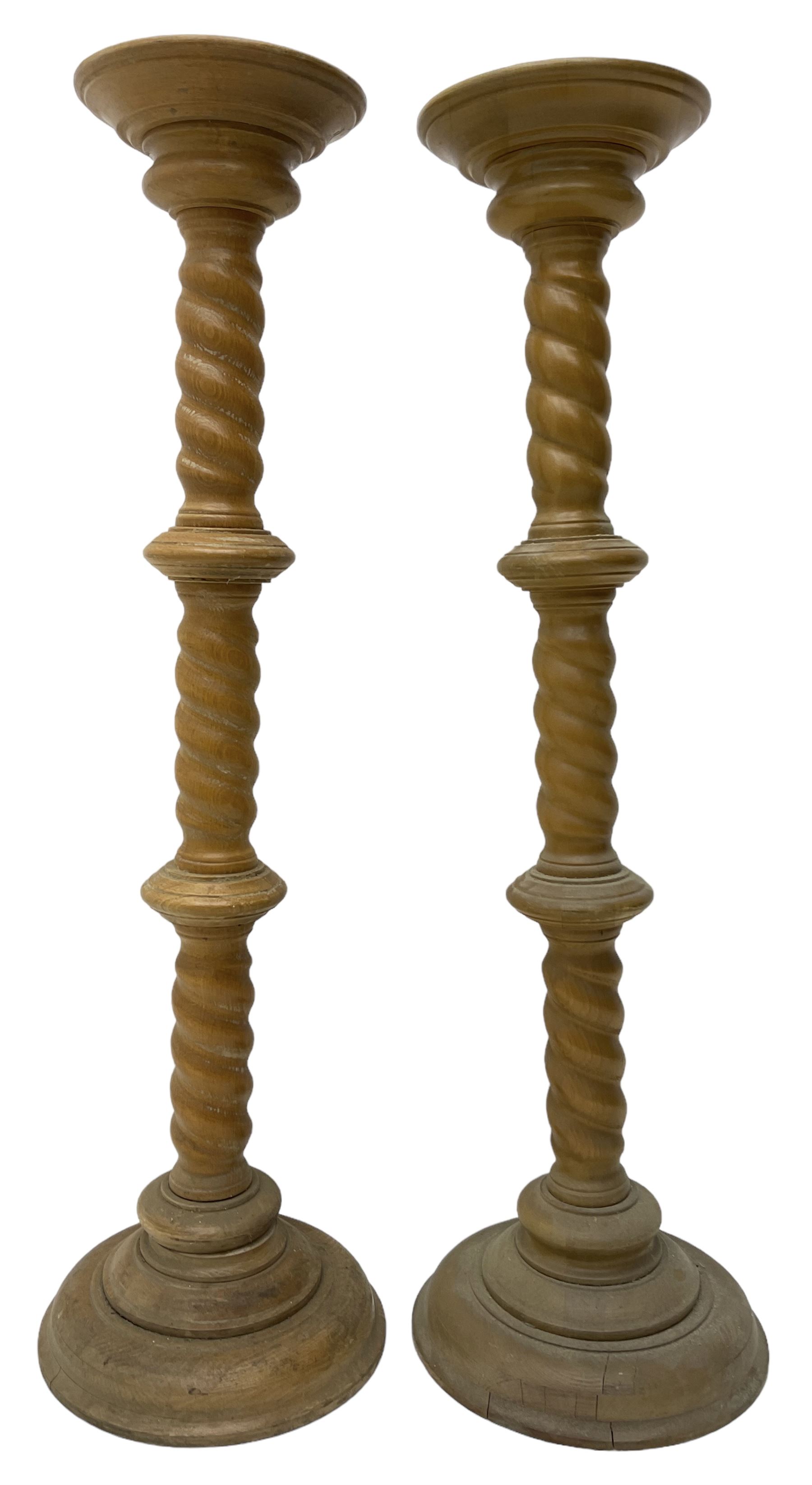 Pair of Victorian design light oak torcheres or jardinieres, circular top with raised lip over a spiral turned column terminating in circular turned plinth base
