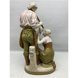 Royal Dux figure group, The Blacksmiths Family, modelled as a man in work clothes and holding a sledgehammer, with kneeling mother supporting young boy, with stamped and impressed mark beneath H61cm