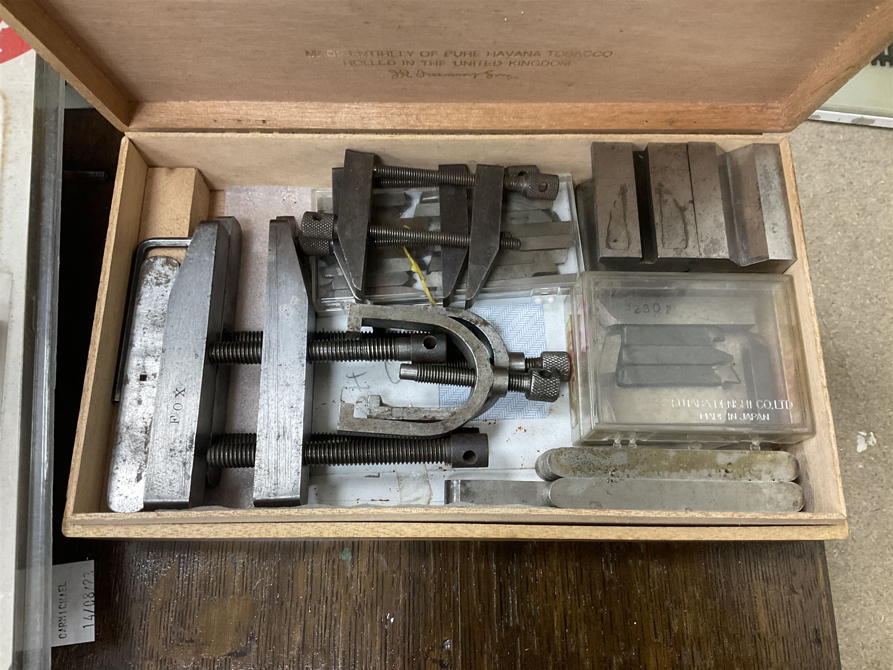 Six shelved cabinets for displaying ‘00’ gauge locomotives comprising plain plywood and white painted examples with track applied to various shelves, largest H63cm, W107cm, D27cm; Collection of tools for building model locomotives to include Weller PU-2D Soldering Pencil and Standard Tip Soldering Iron 20W/230V, Humbrol Modellers Airbrush, Power Supply Units and two wooden chests one of which housing a collection of tools including tweezers, scalping tools, wrenches etc 