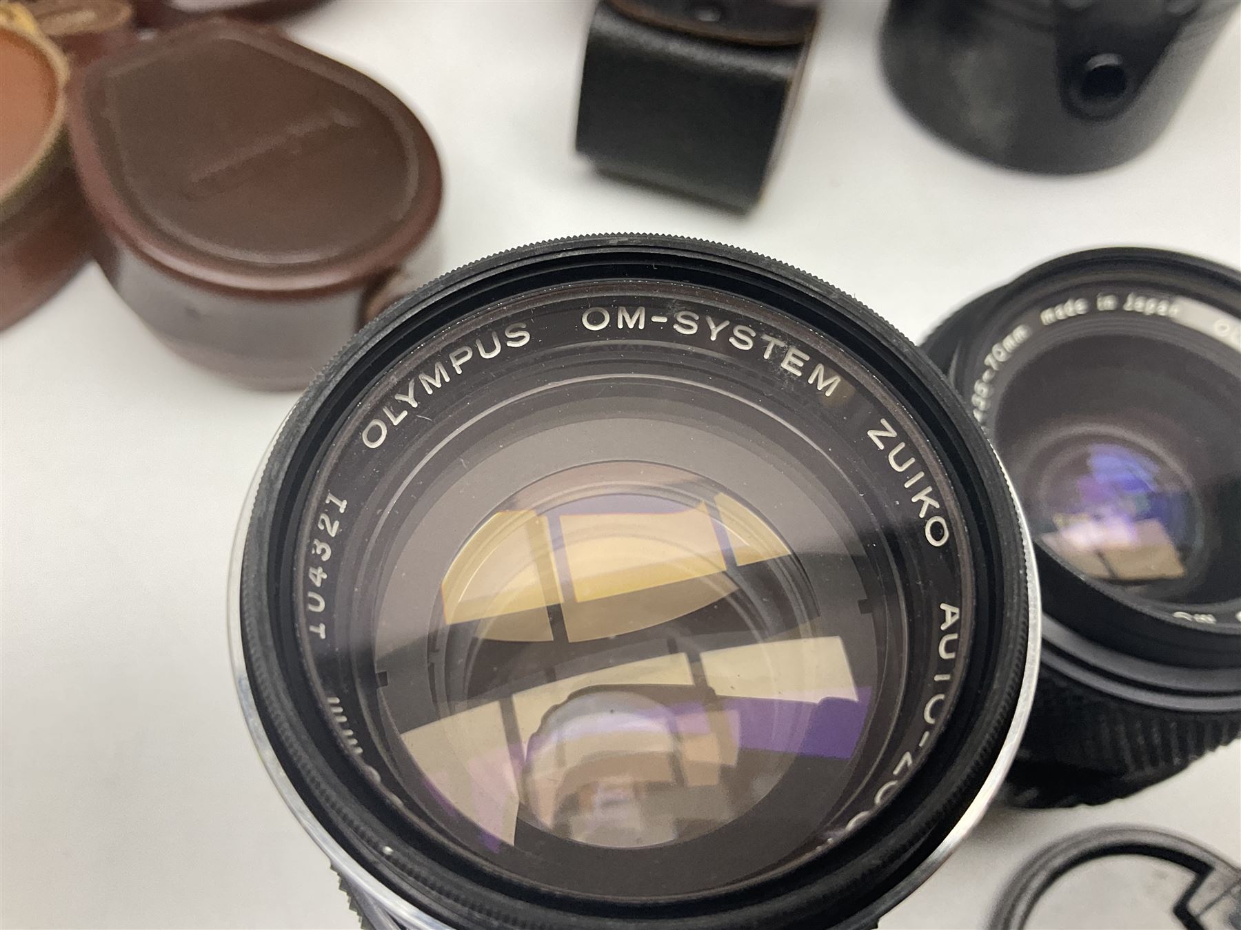 Collection of camera bodies and lenses, to include Olympus OM-1 camera body, serial no 106567, with 'Olympus OM-System F.Zuiko Auto-S 1:1.8 f=50mm' lens, serial no 135097,  Zenit-B camera body, serial no 71017867, with 'Helios-44-2 2/58' serial no 7500040, Voigtlander Vito B camera body, with 'Voigtlander Colour Skopar 1:2.8/50' lens, 'Olympus OM-System Zuiko Auto-Zoom 1:4 f=75-150mm' lens serial no 104321, 'Tamron SP 35-210mm 1:3.5-4.2' lens etc 