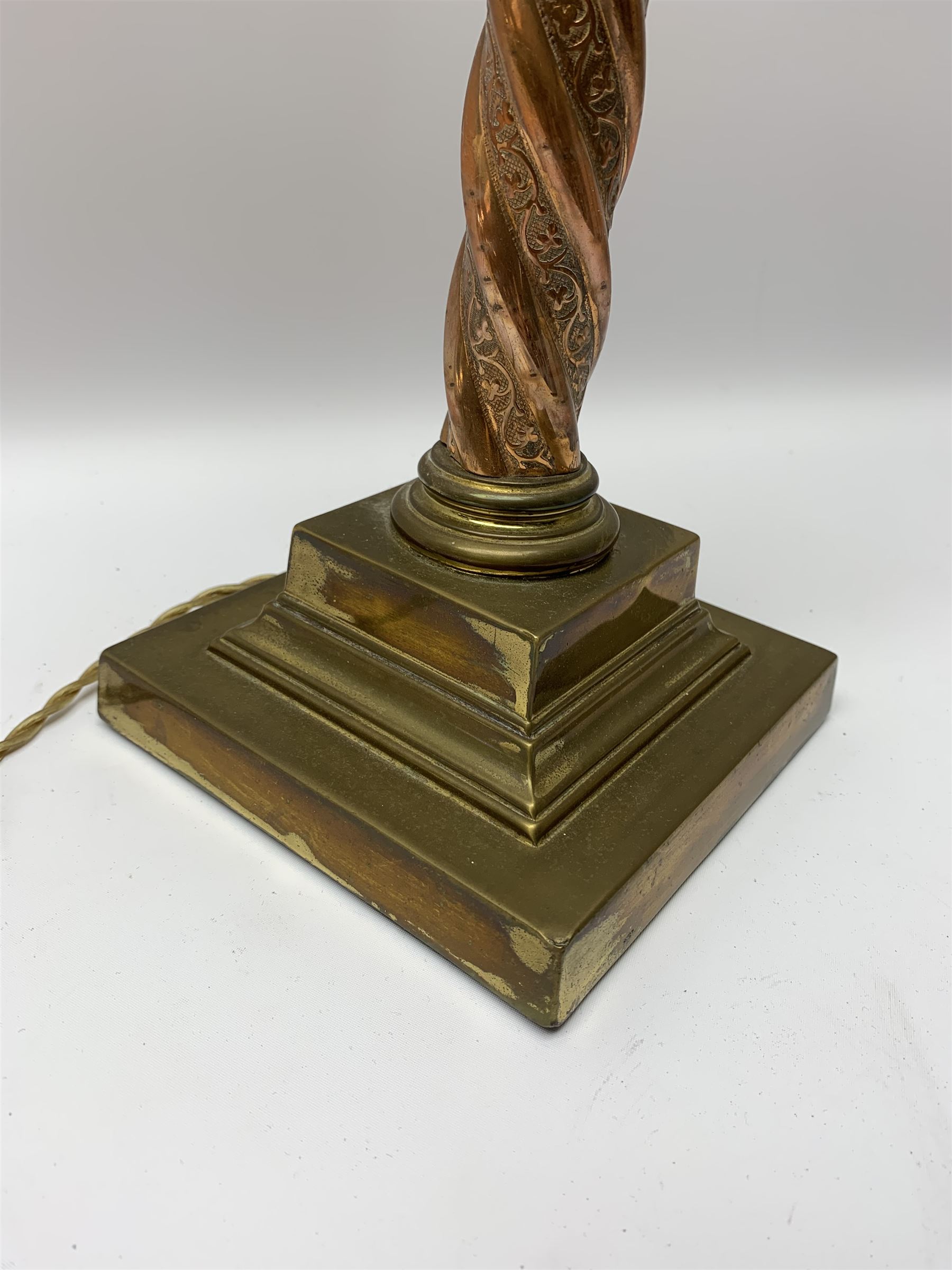 Early 20th century brass and copper Corinthian column table lamp, the square stepped brass base leading to a spiral twist copper column and brass Corinthian capital, H44.5cm 
