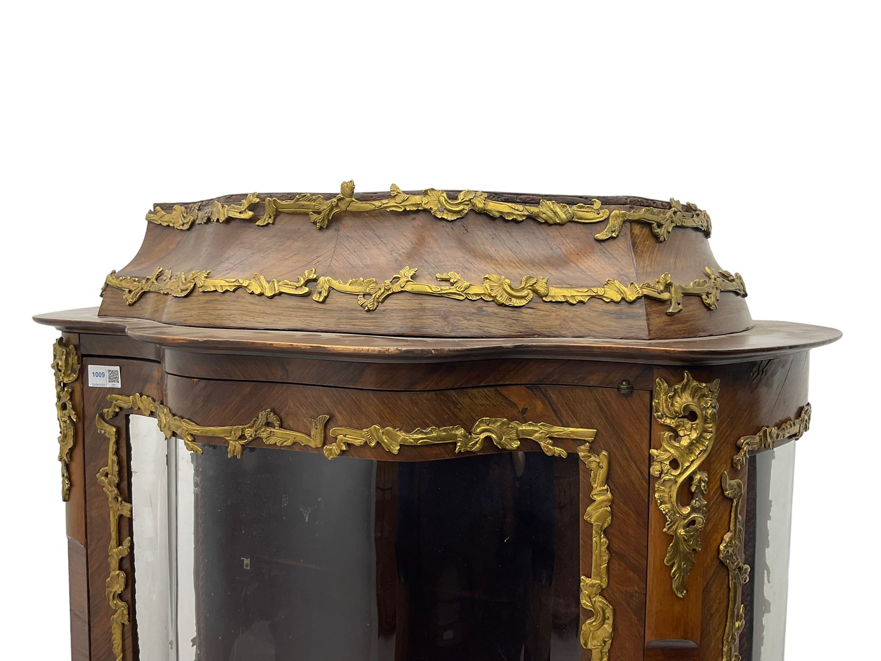 Early 20th century French kingwood vitrine or display cabinet, decorated with applied foliate cast band, serpentine glazed door and sides, inlaid with marquetry decoration of floral bouquets and branches, cartouche mounts to the apron, raised on cabriole supports