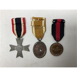 Three WW2 German medals - Defences Medal, Czech Occupation Commemorative Medal and War Merit Cross; all with ribbons (3)