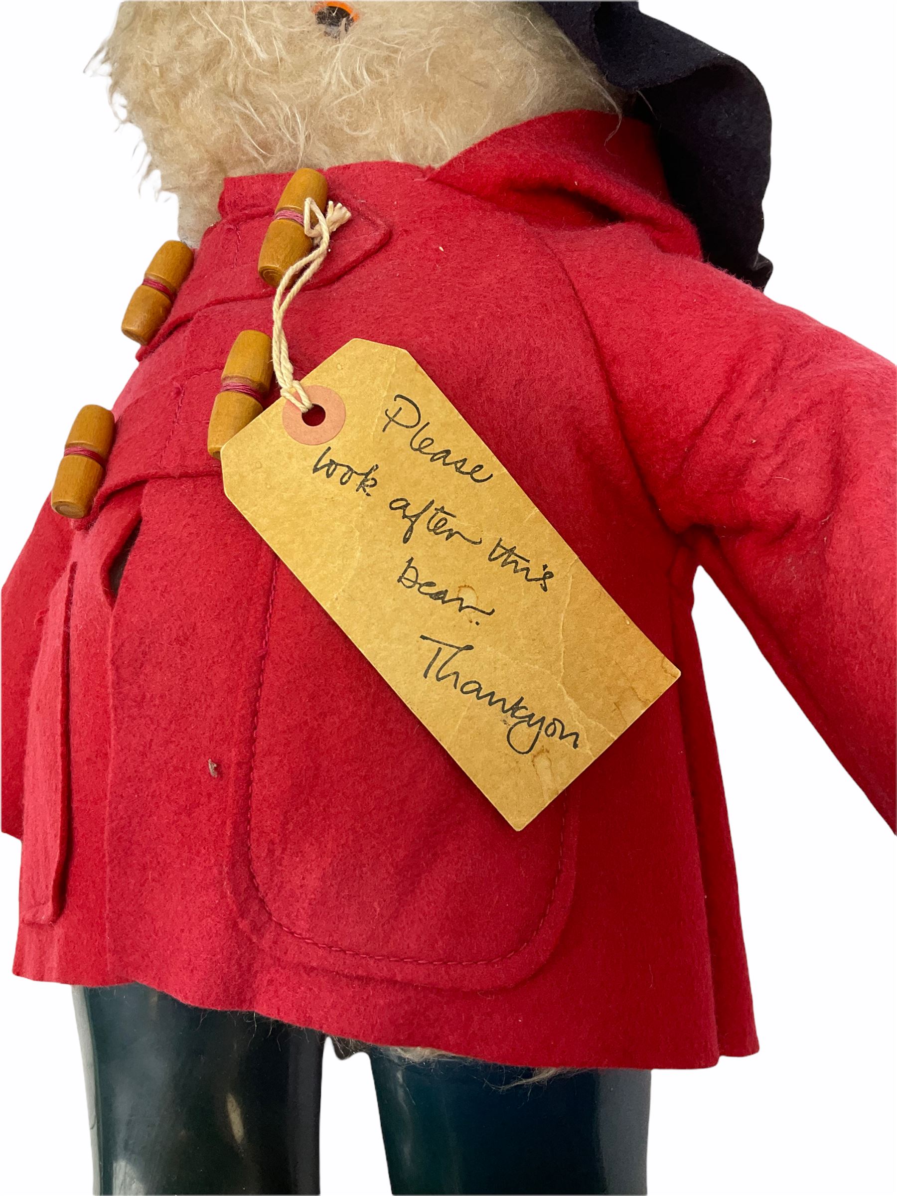 Gabrielle Designs Paddington Bear in a red felt jacket and black felt hat, c1972. Dunlop bottle green wellingtons and Darkest Peru label. H54cm