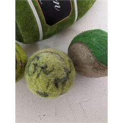 Three tennis balls, two with indistinct signatures, in Wimbledon Lansons Champagne cooler case